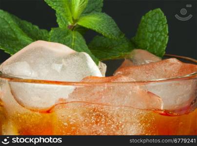 Ice tea with lemon.Closeup glass ice tea with ice cubes and mint.