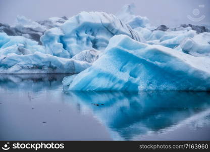 Icebergs in Jokulsarlon beautiful glacial lagoon in Iceland. Jokulsarlon is a famous travel destination in Vatnajokull National Park, southeast Iceland, Europe. Winter landscape.