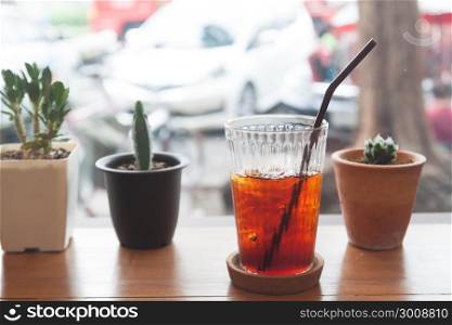 Iced americano on wooden table near the window, Lifestyle