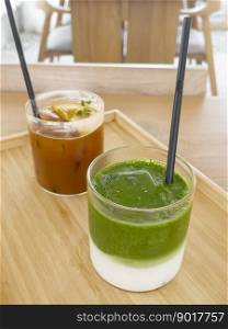 Iced americano with orange and iced matcha green tea in coffee shop, stock photo