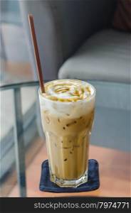 iced caramel macchiato , coffee in glass with drinking straw