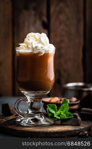 Iced cocoa drink with whipped cream, cold chocolate beverage, coffee frappe on dark background