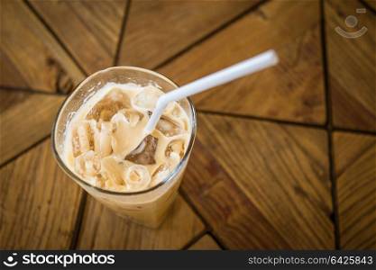 iced coffee glass on wooden table