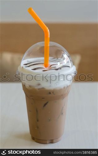 Iced coffee. Iced coffee with straw in plastic cup