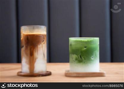 Iced coffee latte and iced matcha greentea on wooden table, stock photo