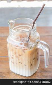 Iced coffee latte in glass pitcher up close, stock photo