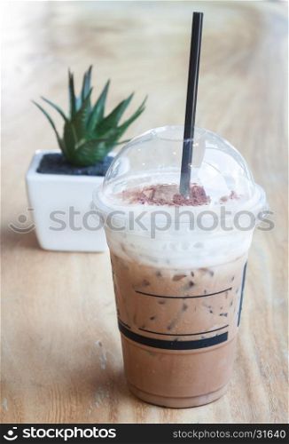 Iced coffee with green plant background, stock photo