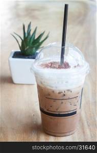 Iced coffee with green plant background, stock photo