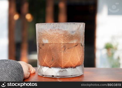 Iced coffee with micro foam in coffee shop, stock photo