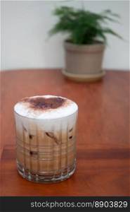 Iced coffee with micro foam in coffee shop, stock photo