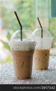 Iced coffee with straw. Iced coffee with straw in plastic cup for take aways