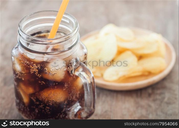 Iced cola with potato chips, stock photo