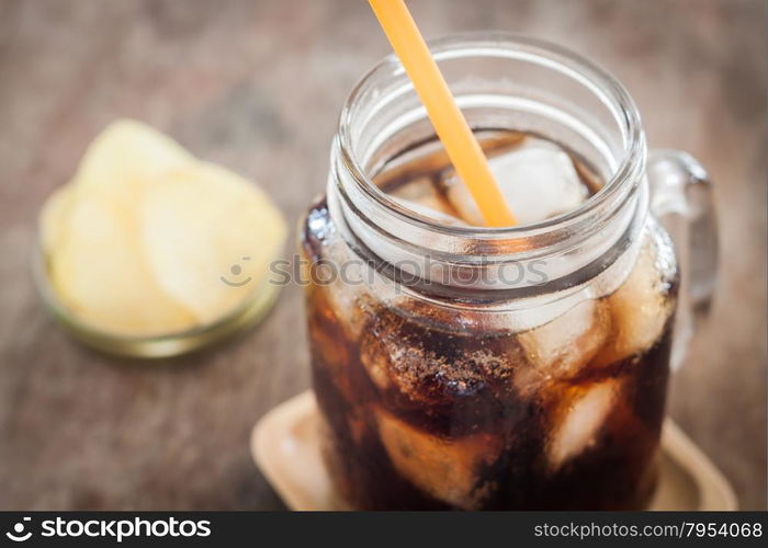 Iced cola with potato chips, stock photo