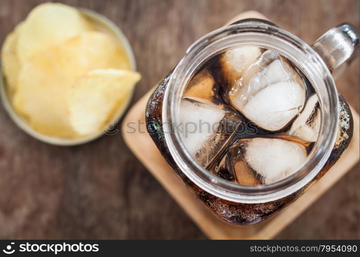 Iced cola with potato chips, stock photo