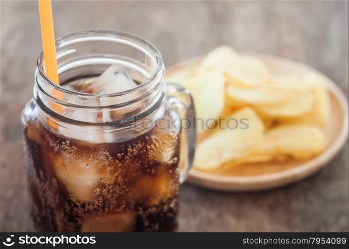 Iced cola with potato chips, stock photo