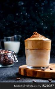 Iced Dalgona Coffee with Water Drops on Dark Background. Trendy Creamy Whipped Coffee. South Korean Cold Summer Drink.. Iced Dalgona Coffee with Water Drops on Dark Background. Trendy Creamy Whipped Coffee. South Korean Cold Summer Drink