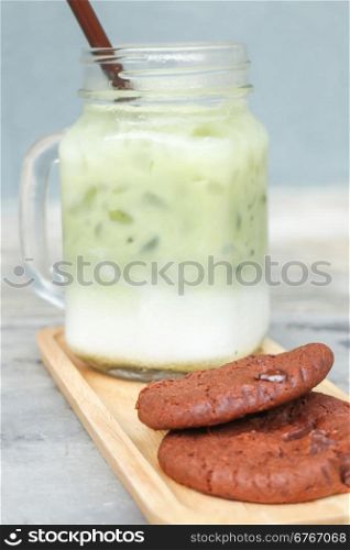 Iced green tea latte and chocolate cookies, stock photo
