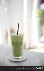 Iced green tea latte in white coffeeshop