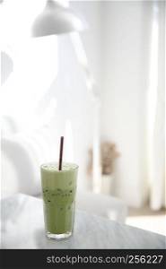 Iced green tea latte in white coffeeshop