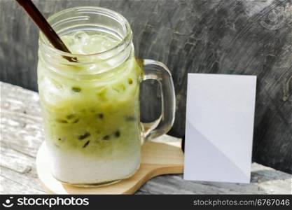 Iced green tea latte with blank name card, stock photo