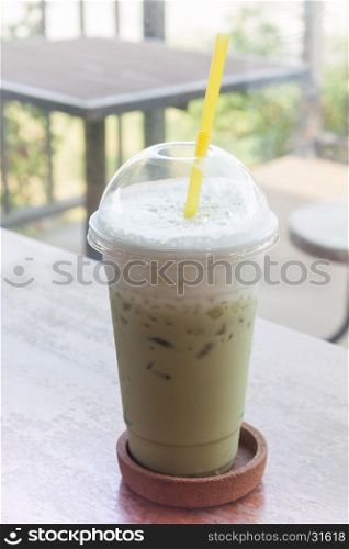Iced green tea on wooden table, stock photo