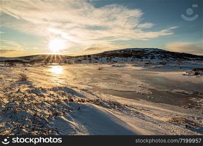 Iced lake in Vifilstadir area in Gardabaer at sunrise, Iceland. Iced lake in Gardabaer at sunrise, Iceland