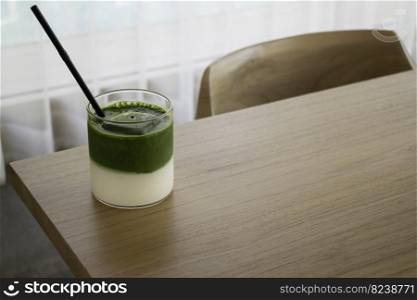 Iced matcha greentea on wooden table, stock photo