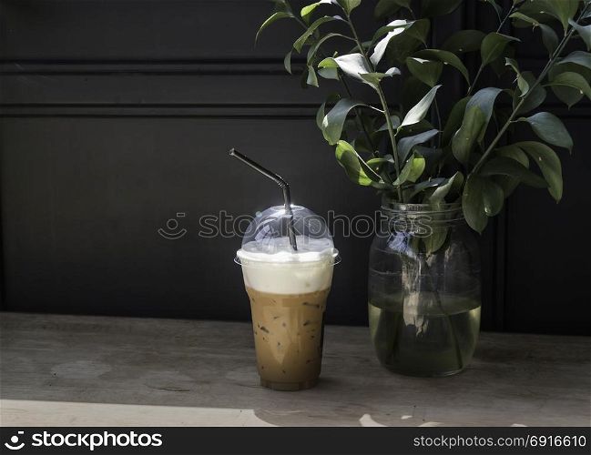 Iced milk coffee on sunshine wooden table, stock photo
