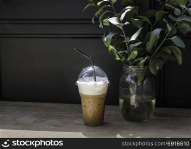 Iced milk coffee on sunshine wooden table, stock photo