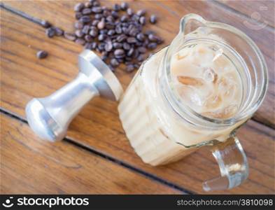 Iced milk coffee on wooden table, stock photo