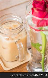 Iced milk coffee serving on wooden table, stock photo