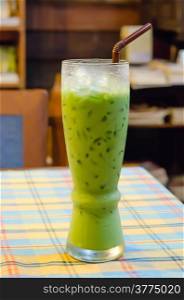 iced milk green tea with straw on table