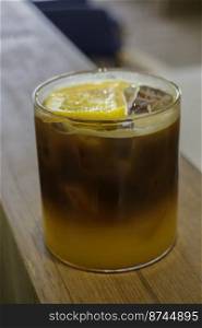 Iced orange juice and black coffee, stock photo