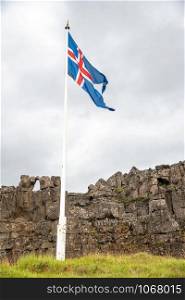 Iceland flag in National Park on a cloudy stormy day