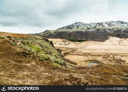 Iceland nature with plains and mountains in cloudy weather