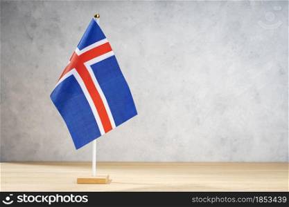 Iceland table flag on white textured wall. Copy space for text, designs or drawings