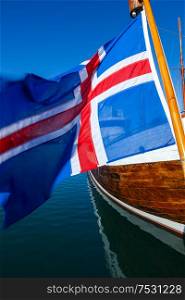 Icelandic flag and traditional wooden boat, Reykjavik Harbor, Iceland