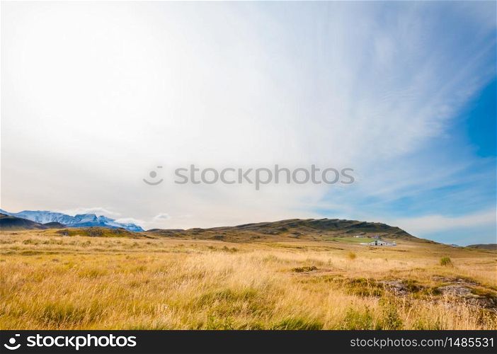Icelandic landscape with volcanic rocks and green grass