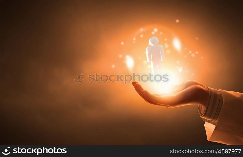 Icon in male hand. Close up of hand holding male figure icon