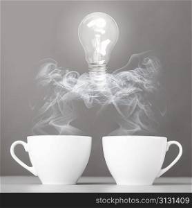idea birth. bulb is lying on steaming hot coffee cups