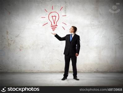 Idea concept. Businessman in suit holding light bulb in palm