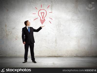 Idea concept. Businessman in suit holding light bulb in palm