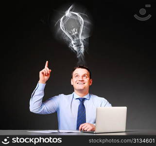 idea concept. businessman is sitting at his table with laptop