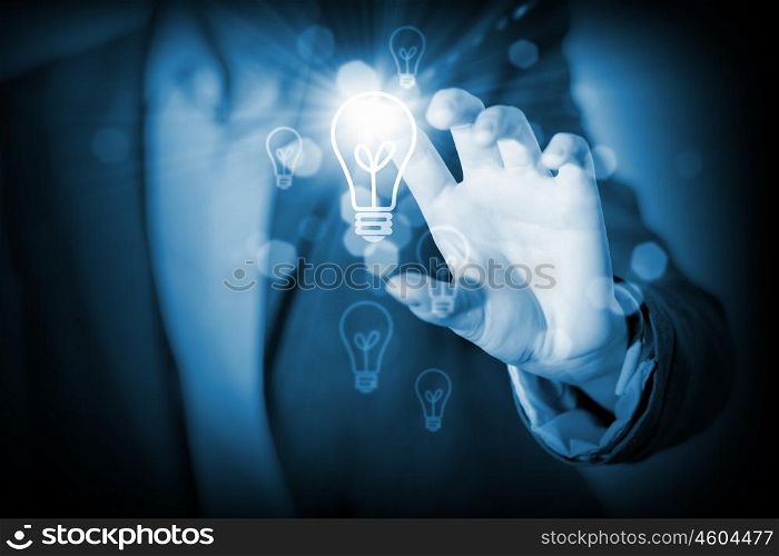 Idea concept. Close up of businessman hand touching icon on media screen