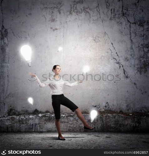 Idea concept. Image of businesswoman juggling with electrical bulbs