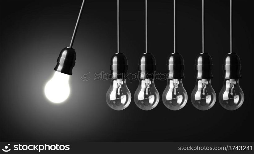 Idea concept on black. Perpetual motion with light bulbs
