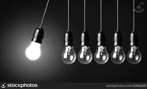 Idea concept on black. Perpetual motion with light bulbs
