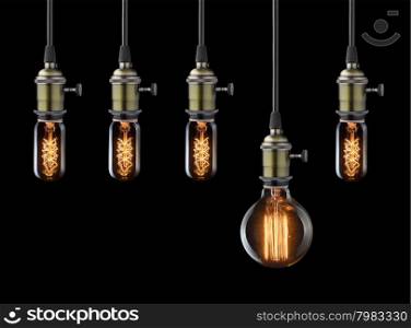 Idea concept. Vintage light bulbs on black