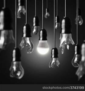 idea concept with broken bulbs and one glowing LED bulb