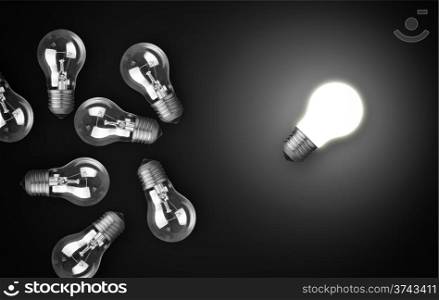 Idea concept with light bulbs, one of them is glowing.
